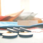 macro detail of wooden tokens, edges covered with blue leather